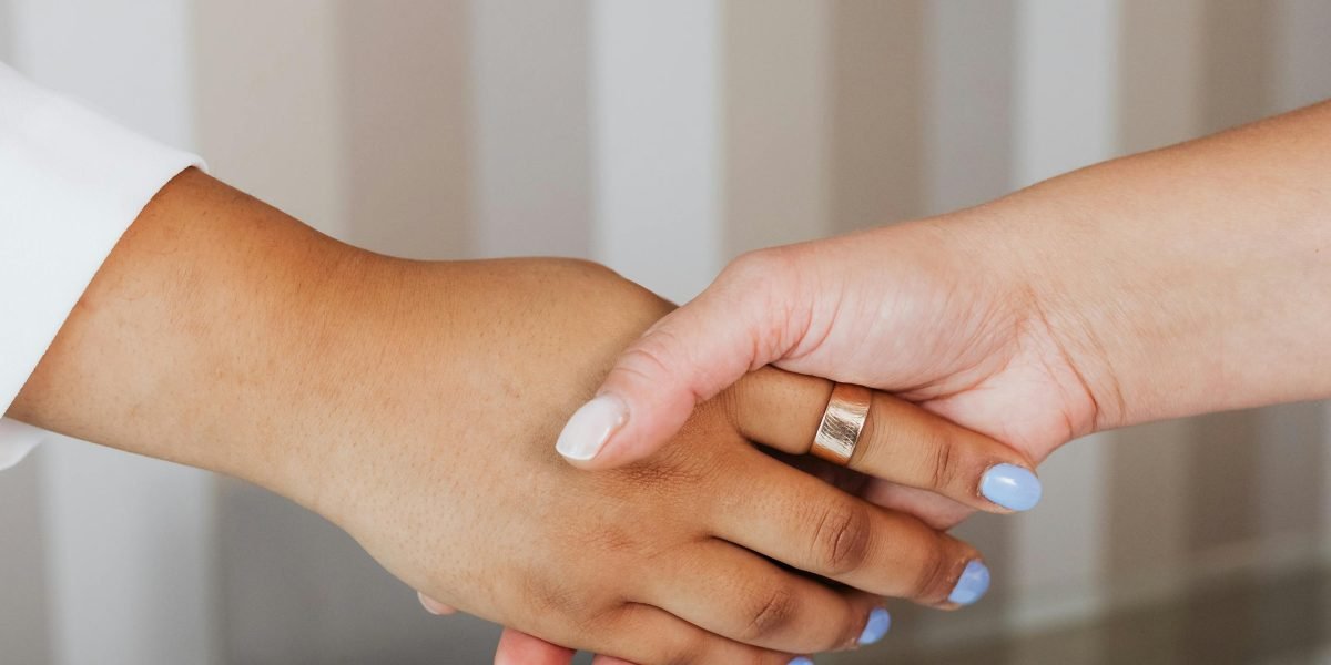 Two professionals shaking hands, signifying a successful agreement and established trust in a business partnership.