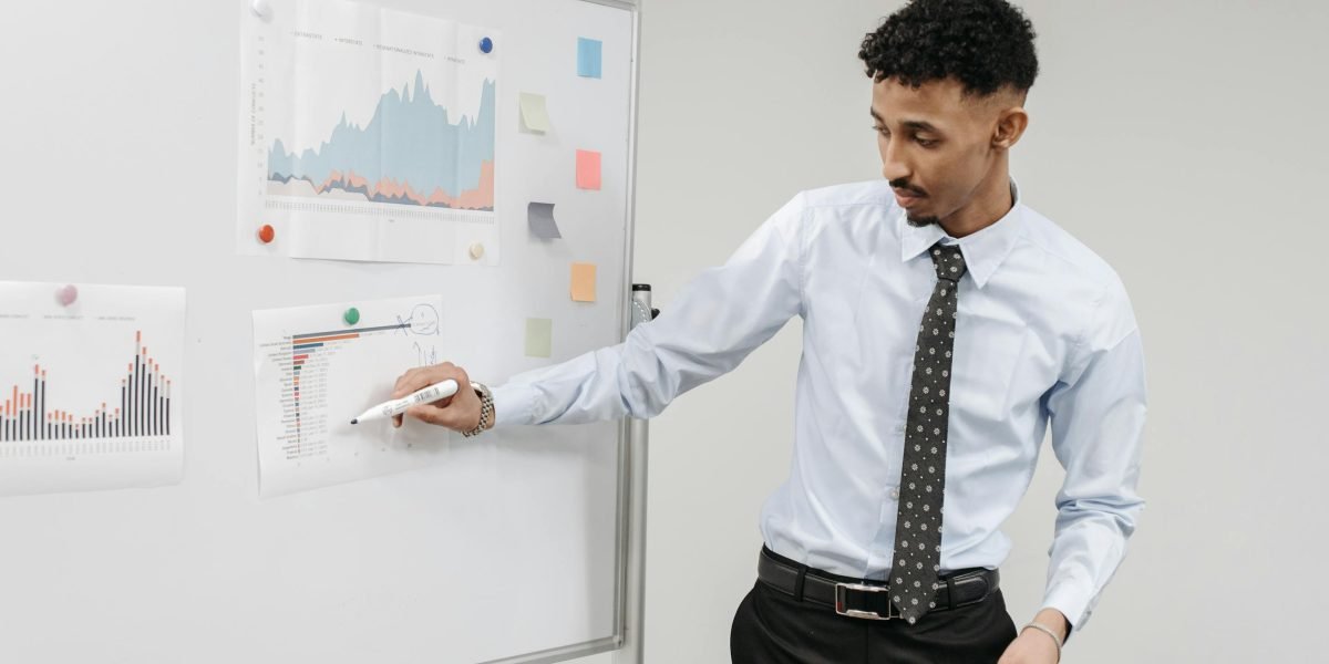 A professional writing ideas on a whiteboard, focusing on content strategy and website optimization.