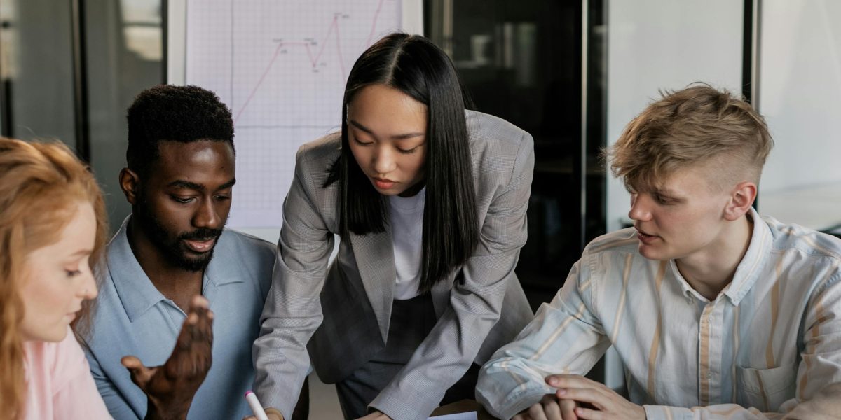 A diverse team working together, combining different skills to form a comprehensive digital marketing plan.