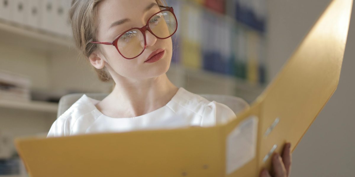 A person carefully reviewing documents or proposals from potential marketing agencies.