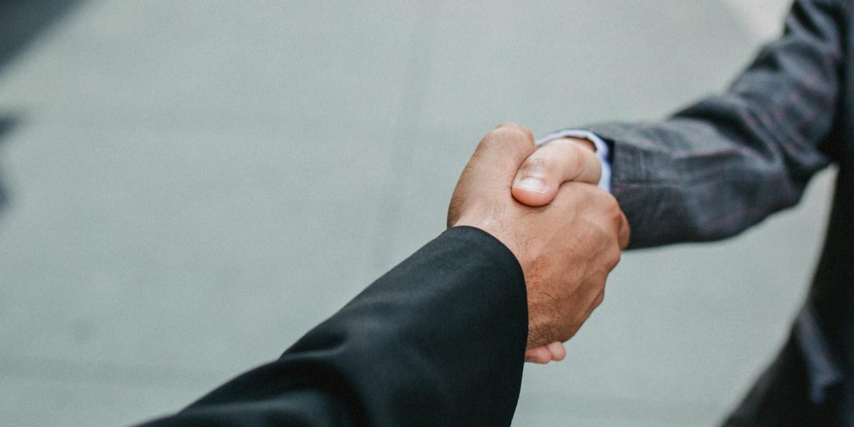 Business professionals shaking hands, symbolizing the start of a new, successful partnership.