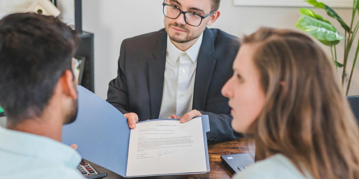 A real estate agent building rapport and trust with a client during a consultation.