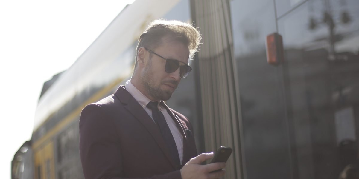 A person checking their phone, representing Dubai's mobile-first audience engaging with emails.