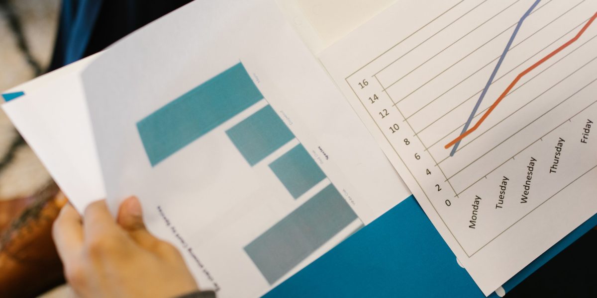 An agent and agency representative reviewing performance reports to evaluate potential marketing partners.