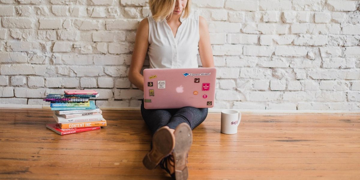 A person focused on writing, symbolizing the effort to create valuable content that establishes expertise and builds trust.