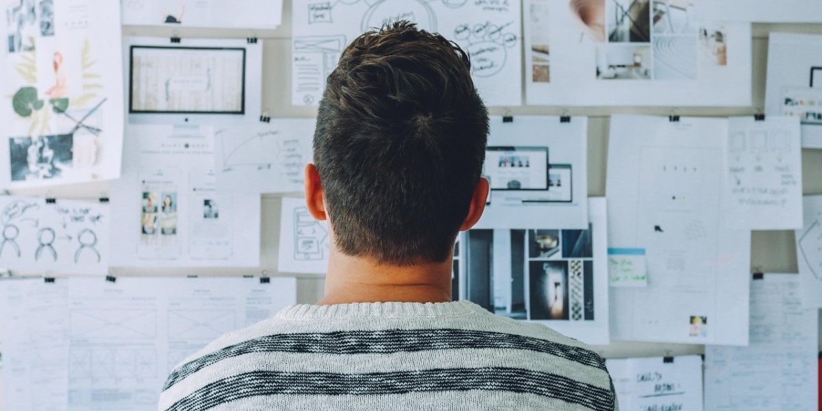 A team actively brainstorming on a whiteboard, defining core values and visual style for a brand identity.