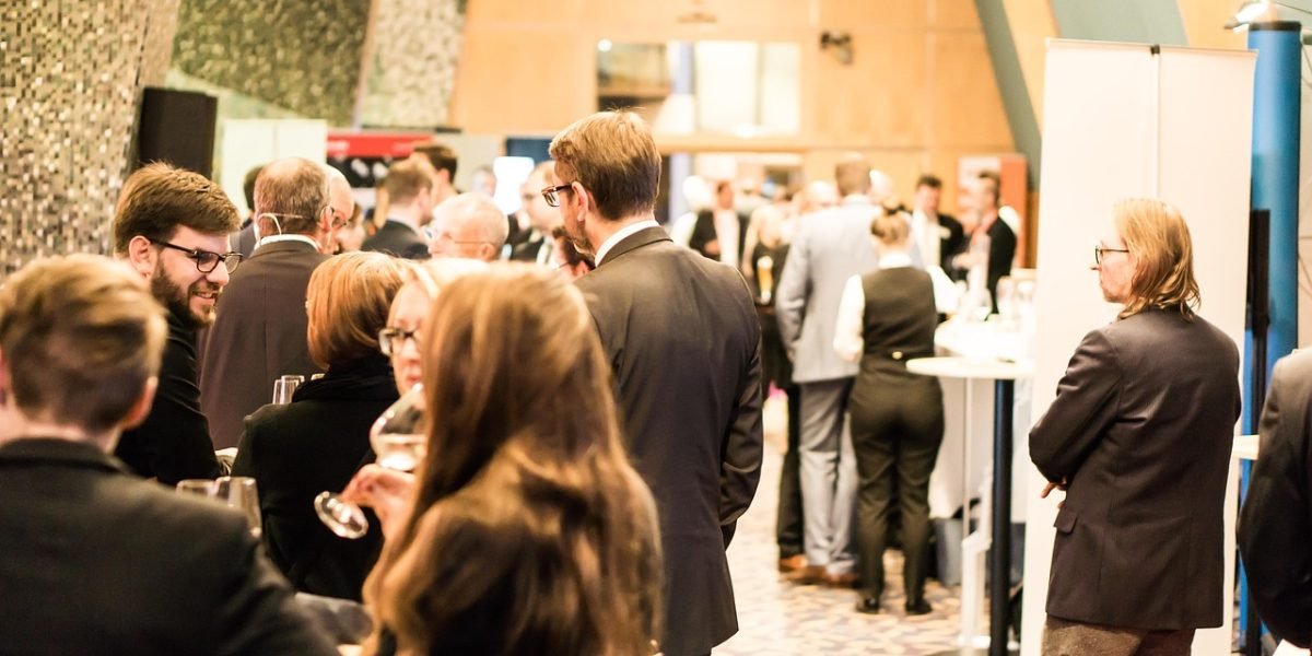 Professionals engaging and networking at a community event, forming valuable partnerships for business growth.