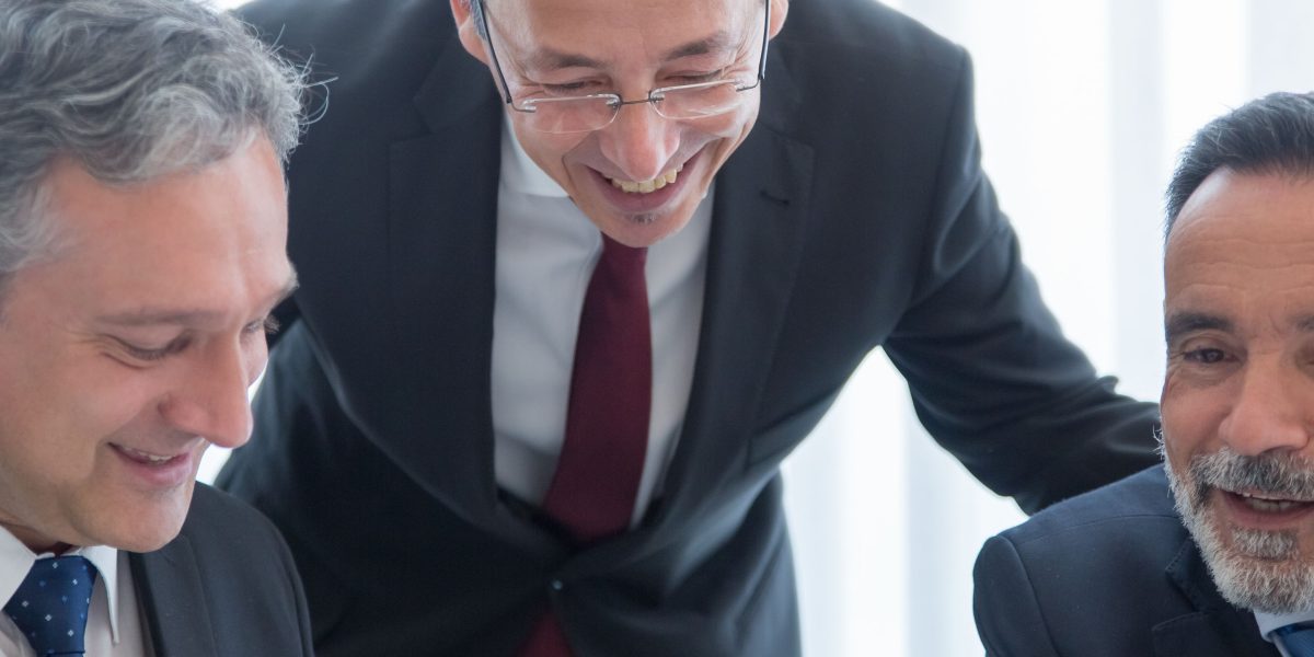 A confident real estate professional leading a discussion, representing success in a competitive market.