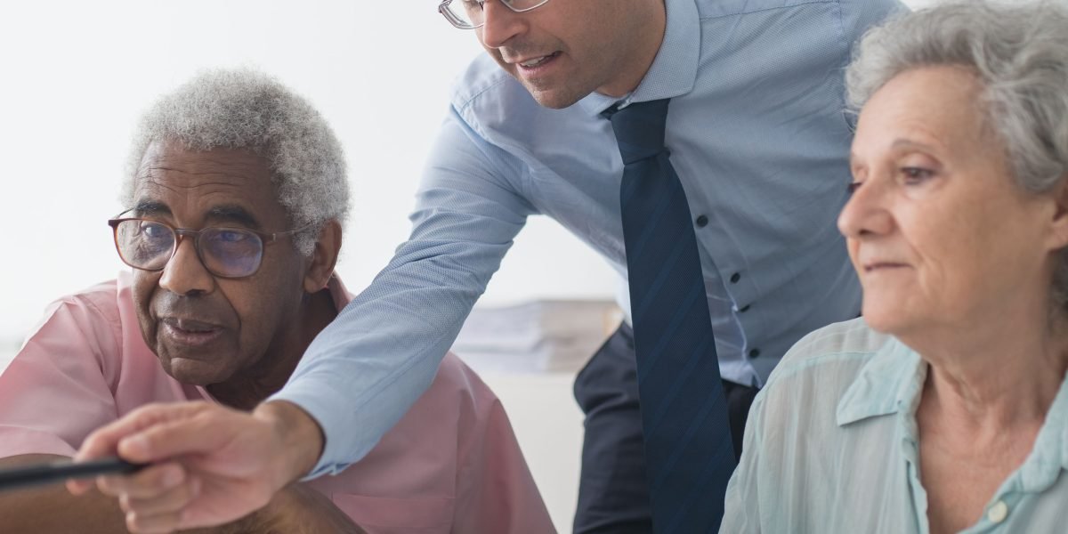 A real estate agent engaging with clients, possibly discussing property locations on a map or tablet, focusing on local expertise.