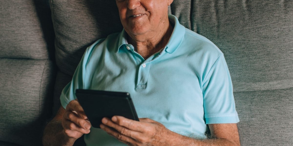 A professional interacting with social media content on a tablet, demonstrating content amplification for real estate marketing.