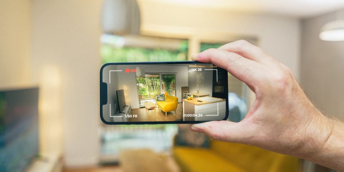 A person engaging with property listings on their mobile phone, highlighting the importance of mobile responsiveness.