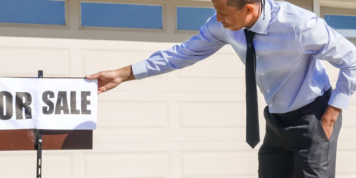 A real estate agent confidently interacting with a client in a modern setting.