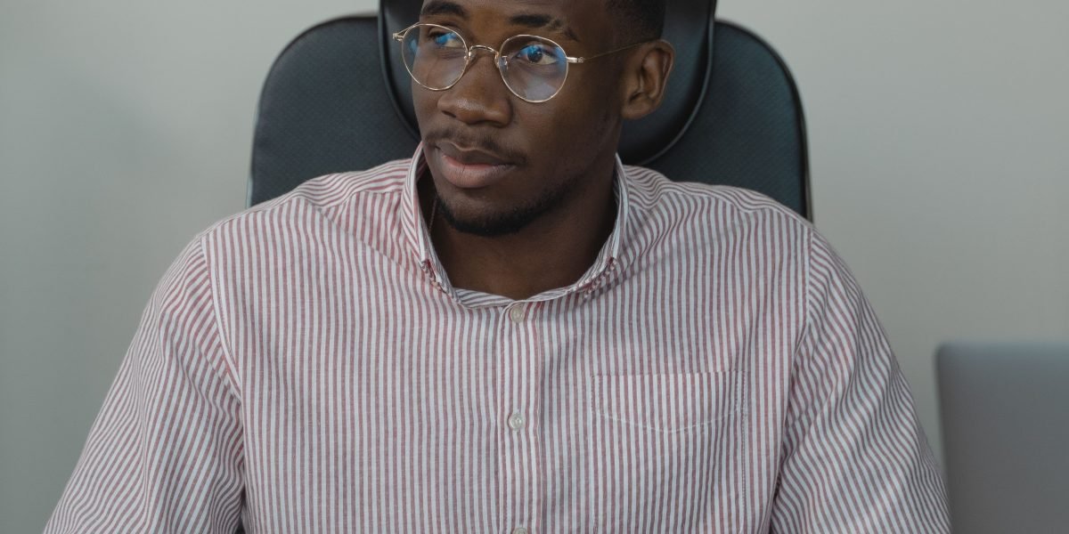 A professional looking confident and thoughtful, representing the challenge of standing out in a competitive market.