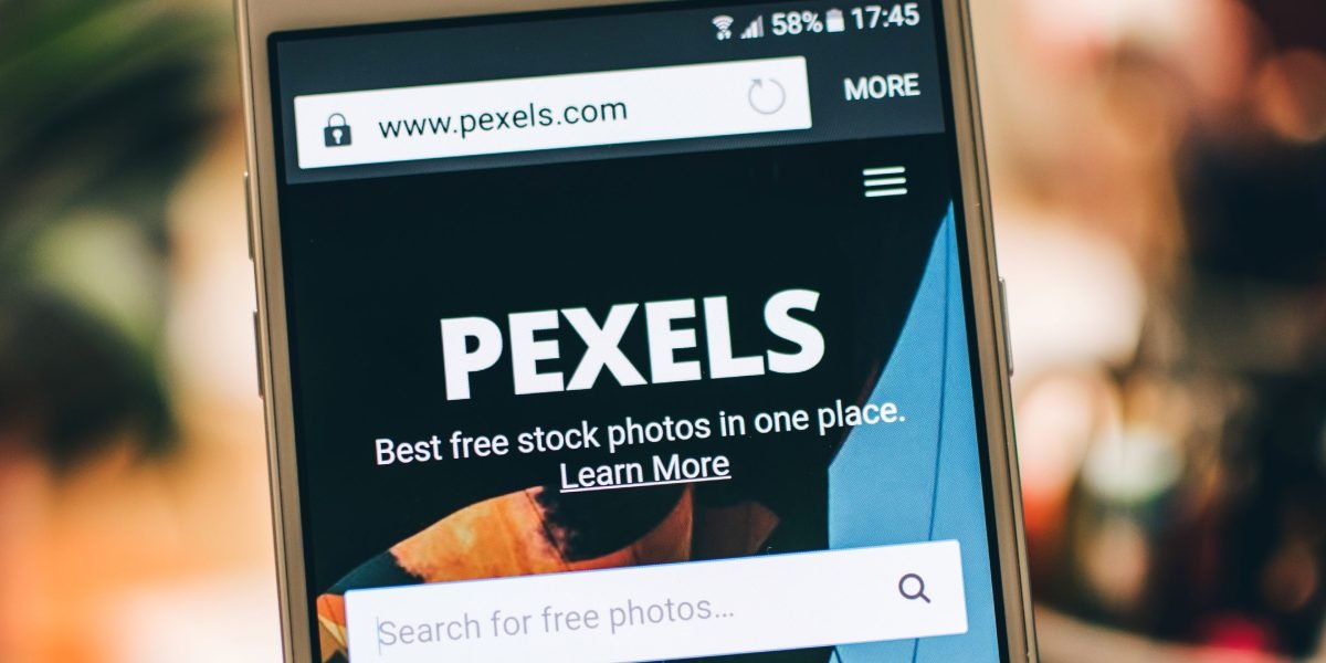 A person using a smartphone to search for properties online, highlighting the digital nature of modern real estate searches.