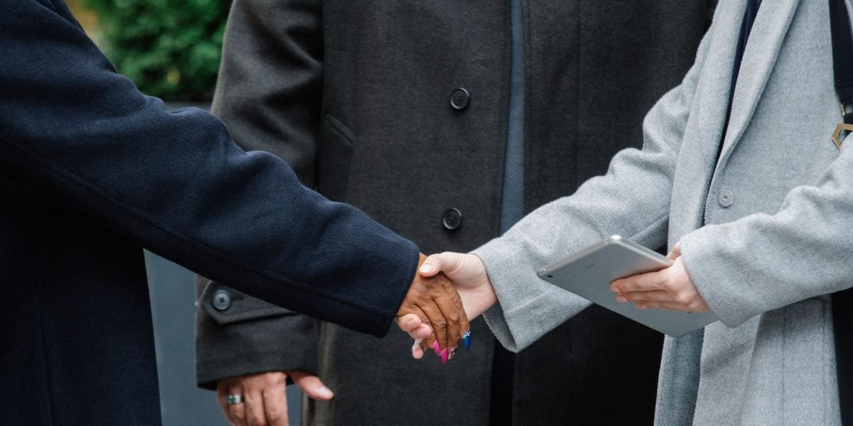 Business professionals shaking hands, symbolizing a successful new partnership for growth.