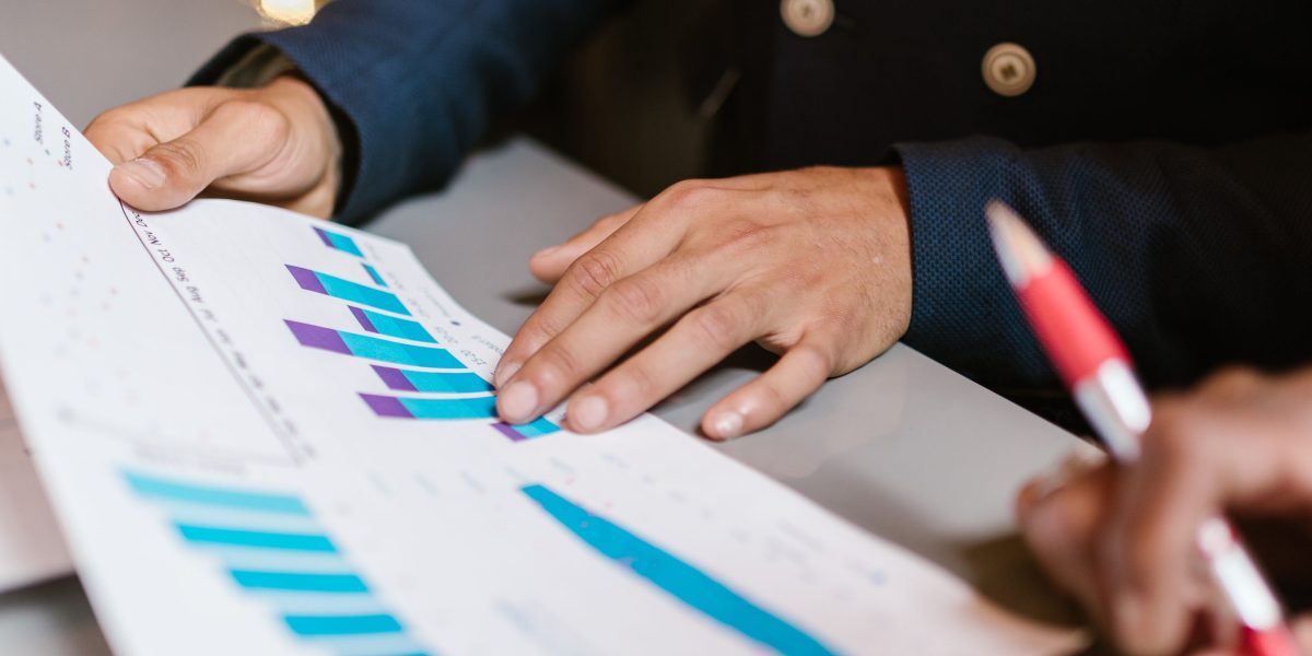 Business professionals analyzing marketing performance data to ensure a positive return on investment.