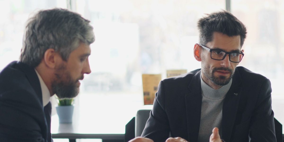 A business owner interacting with people at a local community event, fostering connections.